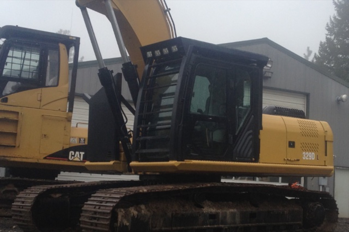 Close view of fabricated cab guarding and catwalk on a CAT 329 excavator