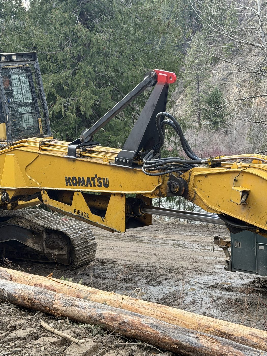 Fabricated elevated anchor point and boom on a Komatsu log loader at a forest site