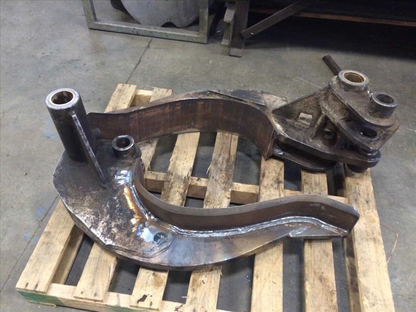 Rebuilt processor knives laid out on a pallet after welding and machining