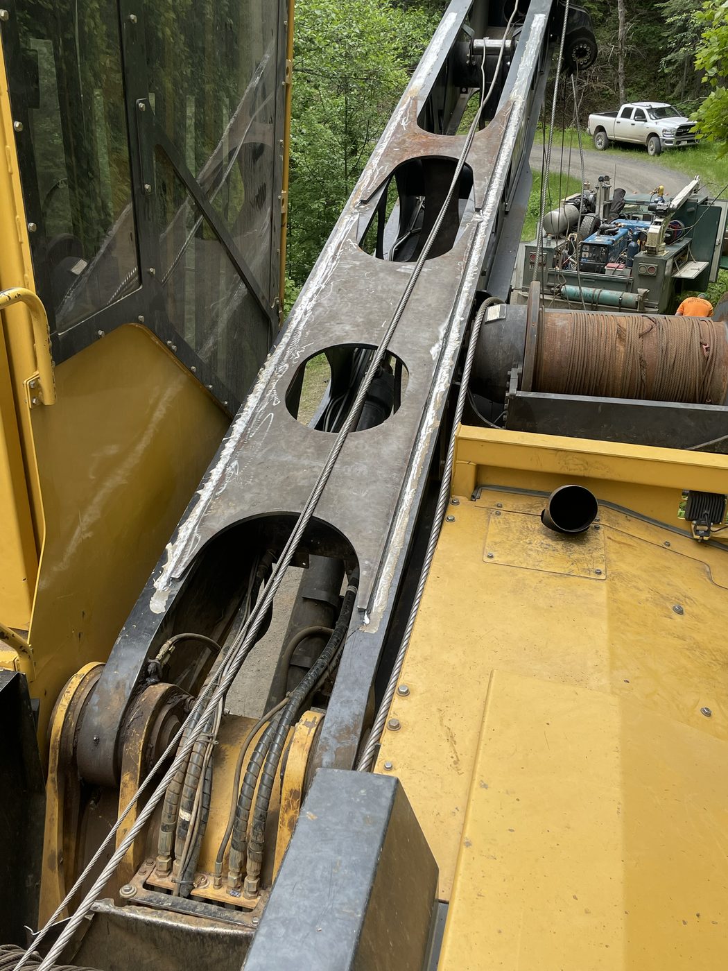 Fabricated boom section with lightening holes on a yellow Tigercat forestry yarder